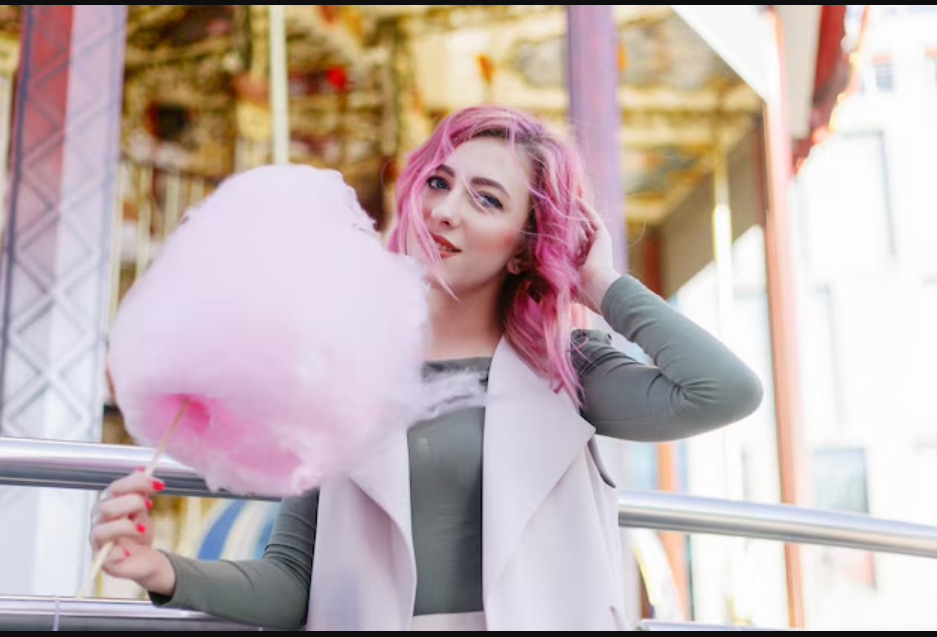 A pink candy cotton in a female hand