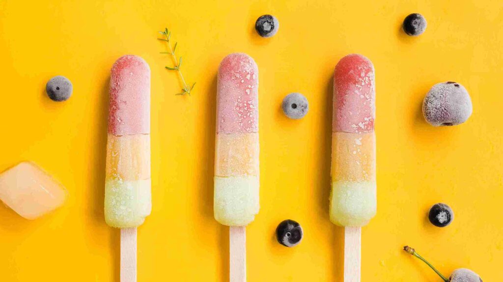 three Rainbow layered popsicle