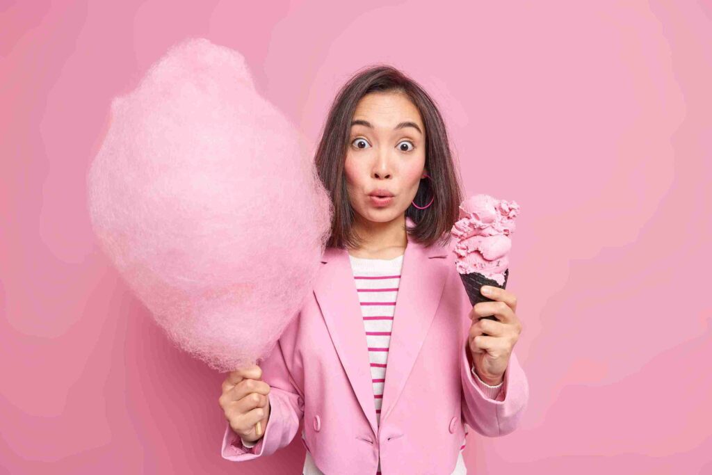 pink cotton candy ice cream in female hand